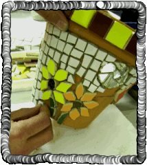 James applying mosaic onto flower pot