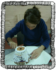 Mary is grouting her second artwork, a flower pot